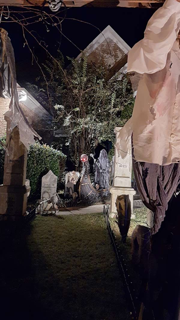 Night Front View of Halloween Graveyard Cemetery with Tombstones and Sleepy Hallow Scarecrow