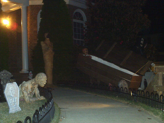 Night View of Graveyard Crawling Ghoul Mummy and Corpse in Coffin