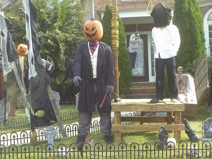 Day View of Gallows, Executioner, Mummy in Coffin with Sleepy Hollow Scarecrow in Background