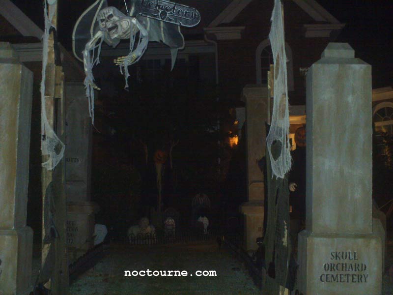 Night View of our Halloween Graveyard Entrance Banner Bat Skeleton Skull Orchard Cemetery