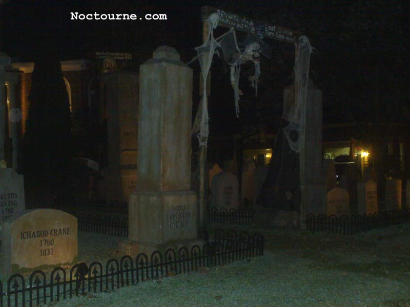 Night View of Halloween Graveyard Entrance Banner Bat Skeleton Skull Orchard Cemetery