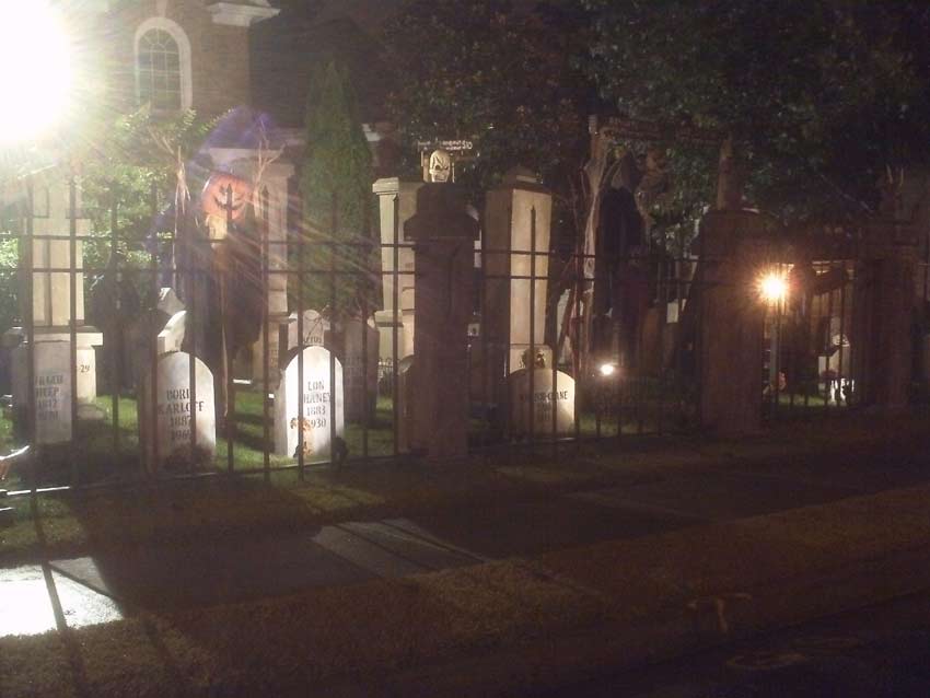 Night View of Halloween Graveyard Entrance Banner Bat Skeleton Skull Orchard Cemetery and Scarecrow