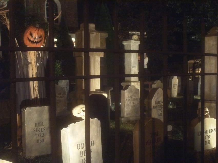 Night Side View of Halloween Graveyard Skull Orchard Cemetery with Tombstones, Tree and Spirit