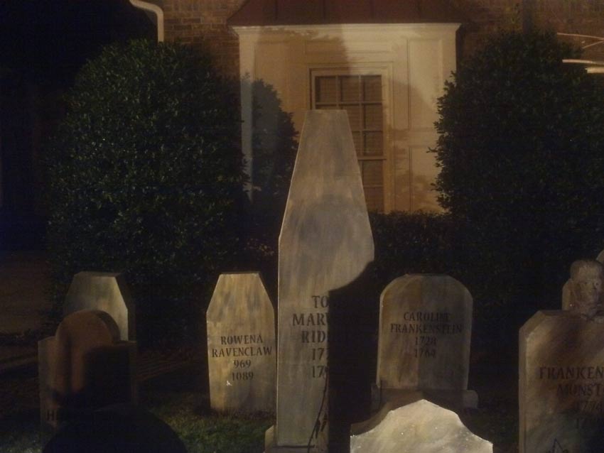 Night Side View of Halloween Graveyard Skull Orchard Cemetery with Tombstones, Tree and Spirit