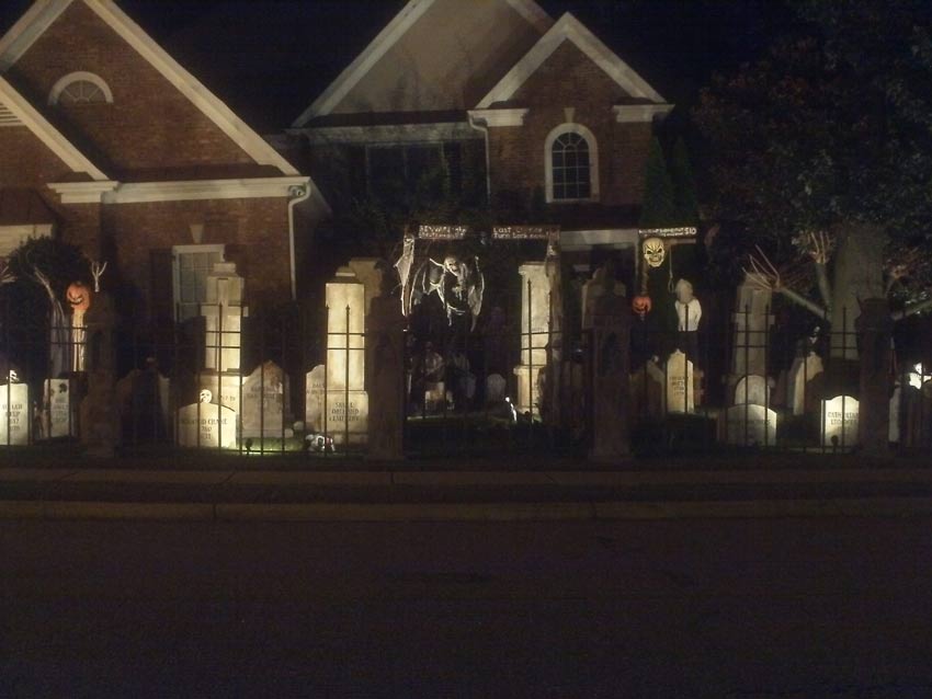 Night Front View of Halloween Graveyard Cemetery with Tombstones and Sleepy Hallow Scarecrow