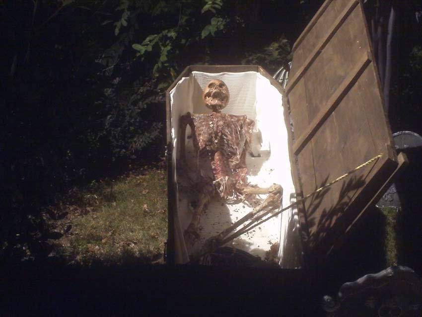 Night Front View of Halloween Graveyard Cemetery with Tombstones and Sleepy Hallow Scarecrow